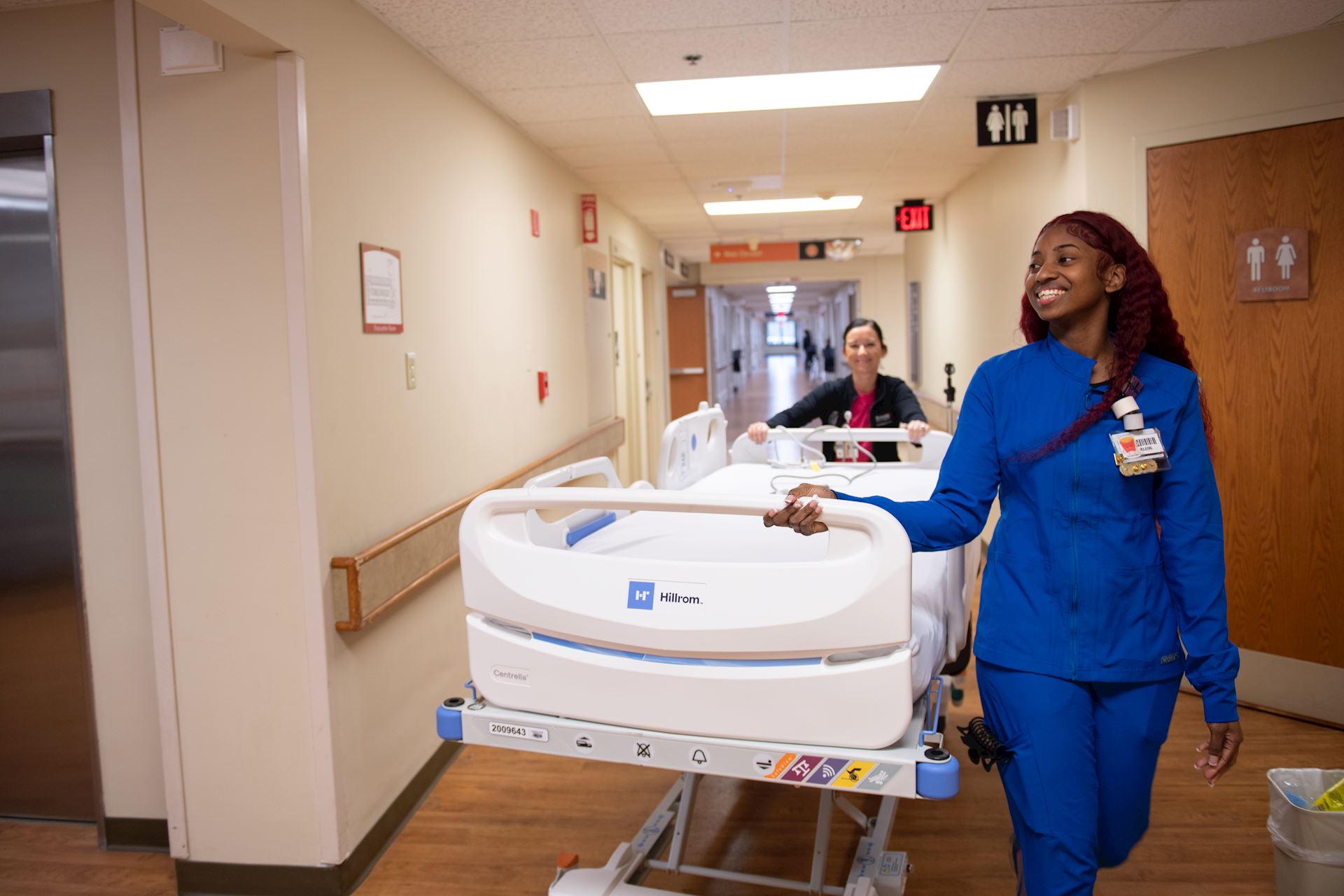 A person pushing a hospital bed